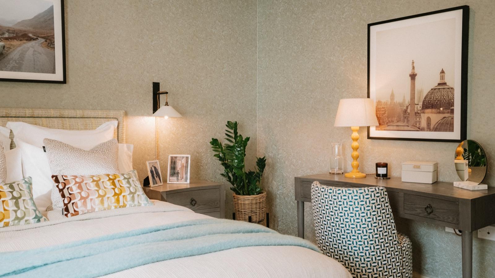 Bedroom with upholstered bench and bedside lamp in a 4WALLS show home