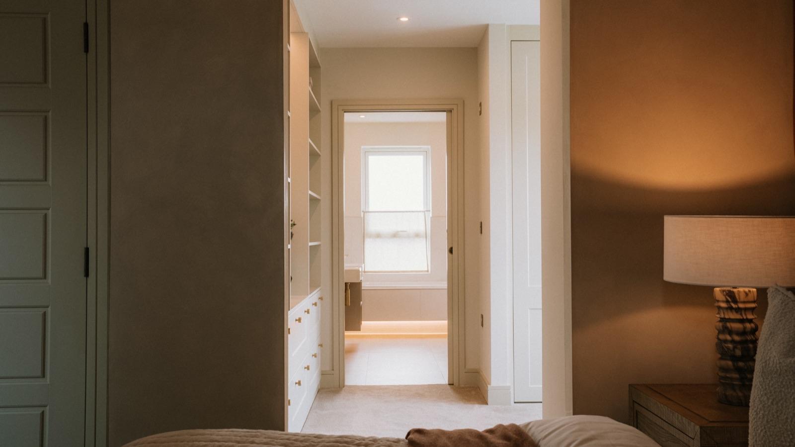 Hallway leading to an ensuite bathroom in a new build apartment